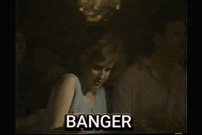 A Man Is Playing A Guitar On Stage In A Black And White Photo With The Word Banger . GIF