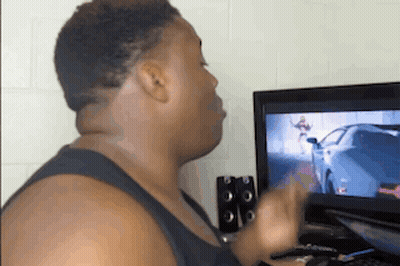 A Man Is Playing A Video Game On A Computer . GIF