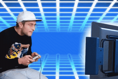 A Man Is Playing A Video Game With A Controller GIF