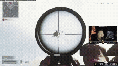 A Man Is Playing A Video Game With A Helicopter In The Scope Of His Sniper Rifle GIF