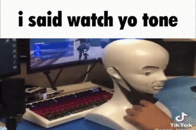 A Man Is Playing A Video Game With A Mannequin Head In Front Of A Computer Monitor And Keyboard GIF