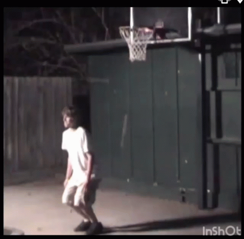 A Man Is Playing Basketball In Front Of A Basketball Hoop That Says Inshot On The Bottom GIF