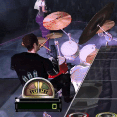 A Man Is Playing Drums In A Video Game With The Word Rock On The Screen GIF