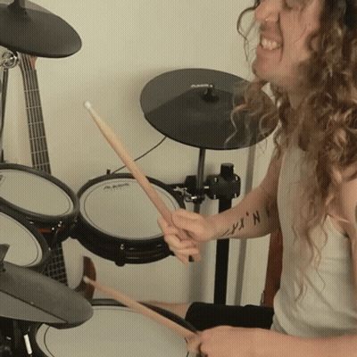 A Man Is Playing Drums With A Shirt That Says ' N.k. ' On It GIF