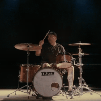 a man is playing drums with a truth drum