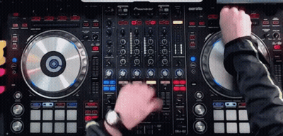 A Man Is Playing Music On A Pioneer Dj Controller GIF