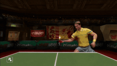 A Man Is Playing Ping Pong In A Video Game With A Nitto Logo In The Background GIF