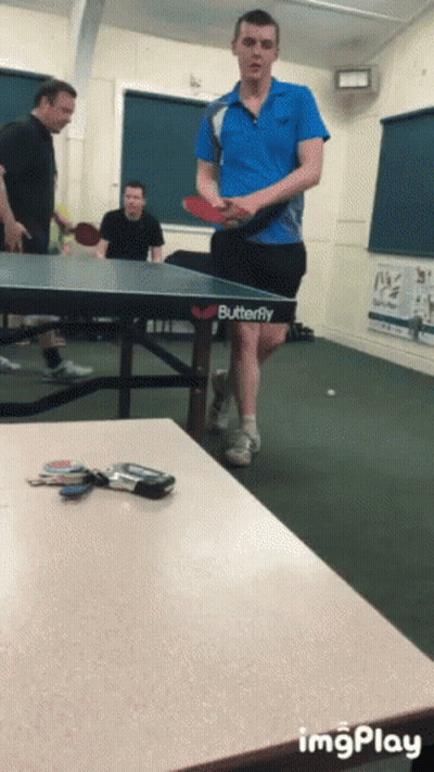 A Man Is Playing Ping Pong On A Table That Says Butterfly GIF