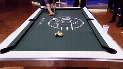 A Man Is Playing Pool On A Table That Says The Note GIF
