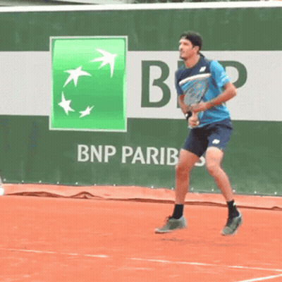 A Man Is Playing Tennis In Front Of A Bnp Pariba Ad GIF