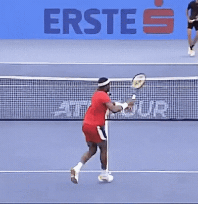 A Man Is Playing Tennis On A Court With A Sign That Says Erste On It GIF