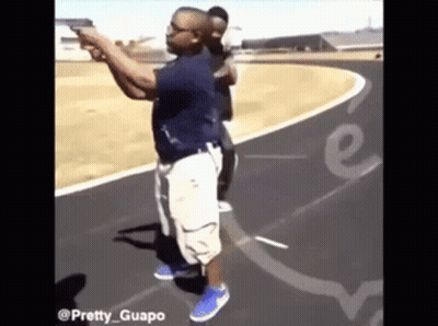 A Man Is Pointing A Gun At Another Man On A Track With The Words Pretty Guapo On The Bottom GIF