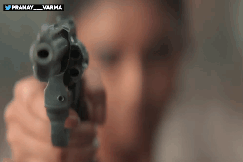 A Man Is Pointing A Gun At The Camera With The Words Pranay_varma On The Bottom GIF