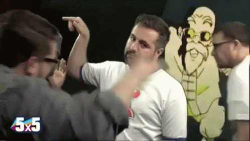 A Man Is Pointing At Another Man In Front Of A Cartoon Character With The Number 5X5 On The Bottom Right GIF