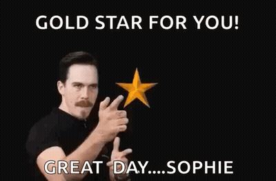 A Man Is Pointing At Two Gold Stars In The Air . GIF