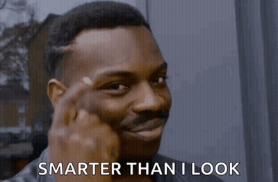 A Man Is Pointing His Finger At His Forehead And Saying Smarter Than I Look GIF