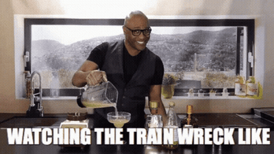 A Man Is Pouring A Drink Into A Glass With The Words " Watching The Train Wreck Like " Above Him GIF