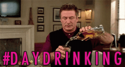 A Man Is Pouring A Glass Of Alcohol From A Bottle . GIF