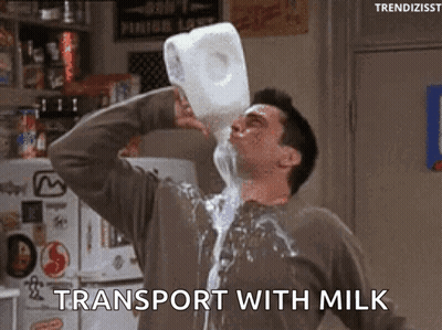 A Man Is Pouring Milk From A Gallon Into His Mouth . GIF