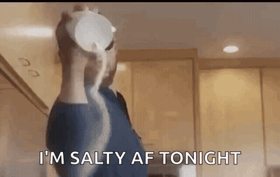 A Man Is Pouring Salt Into A Bowl In A Kitchen . GIF