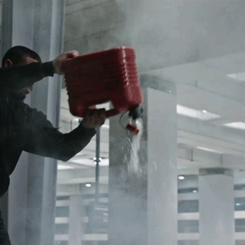 A Man Is Pouring Water From A Red Bucket Into A Window GIF