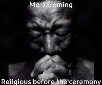 A Man Is Praying In A Black And White Photo . GIF