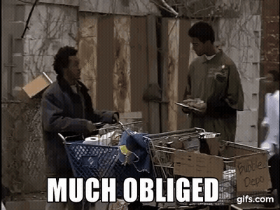 A Man Is Pushing A Shopping Cart With A Sign That Says `` Much Obliged '' Next To Him . GIF