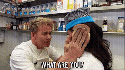 A Man Is Putting A Piece Of Bread On A Woman 'S Ear And Asking What Are You ? GIF