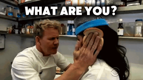 A Man Is Putting A Piece Of Bread On A Woman 'S Ear And The Words What Are You Are Above Him GIF