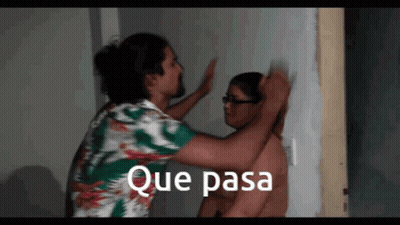 A Man Is Putting His Hand On Another Man 'S Head With The Words Que Pasa Written Above Him GIF