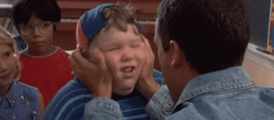 A Man Is Putting His Hands On A Boy 'S Face . GIF