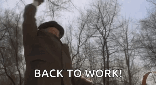 A Man Is Raising His Fist In The Air And Saying `` Back To Work ! '' GIF