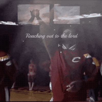 A Man Is Reaching Out To The Lord In A Crowd GIF