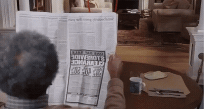 A Man Is Reading A Newspaper With A Headline That Says 30 GIF