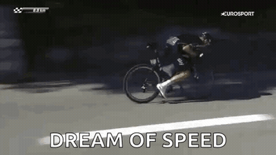A Man Is Riding A Bicycle Down A Road And The Words `` Dream Of Speed '' Are Being Displayed . GIF