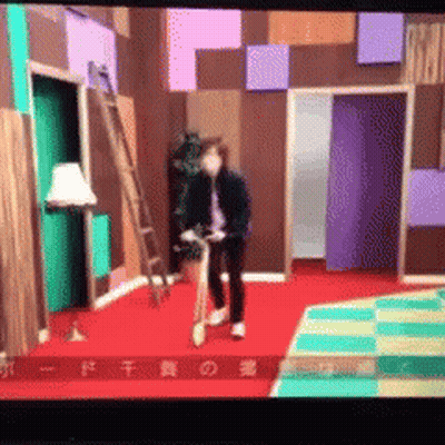A Man Is Riding A Bike In A Room With Chinese Characters On The Bottom GIF