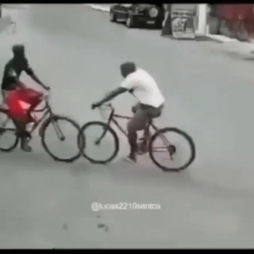 A Man Is Riding A Bike Next To A Woman On A Bike GIF