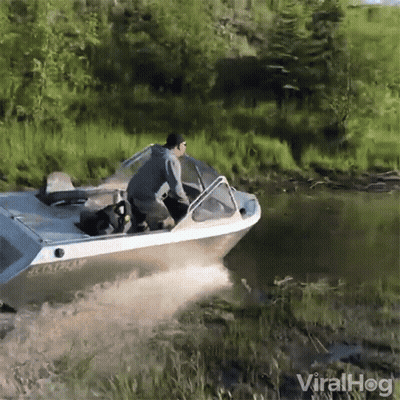 A Man Is Riding A Boat In A River With The Words Viralhog In The Corner GIF