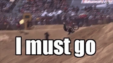 A Man Is Riding A Dirt Bike On A Track And The Words I Must Go Are Visible GIF