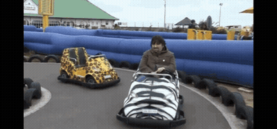 A Man Is Riding A Go Kart With A License Plate That Says ' Aa ' On It GIF