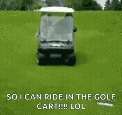 A Man Is Riding A Golf Cart On A Golf Course With A Golf Bag On The Back . GIF