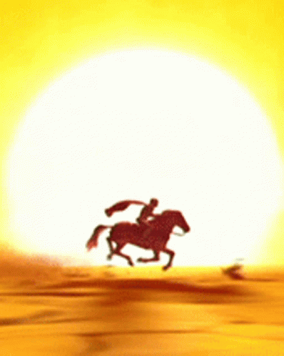 A Man Is Riding A Horse In The Desert GIF