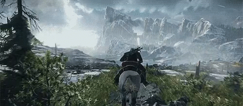 A Man Is Riding A Horse Through A Snowy Mountainous Area GIF
