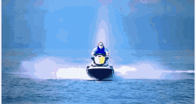 A Man Is Riding A Jet Ski In The Water GIF