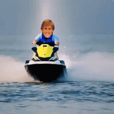A Man Is Riding A Jet Ski In The Water GIF
