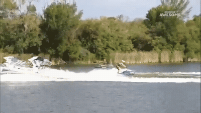 A Man Is Riding A Jet Ski On A Lake And The Words Awesome Are On The Bottom Of The Screen GIF