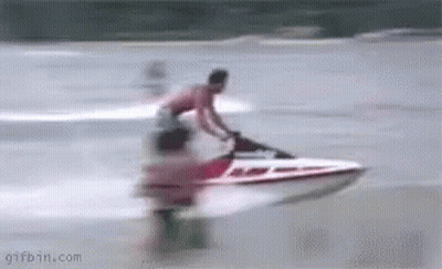 A Man Is Riding A Jet Ski On The Water . GIF