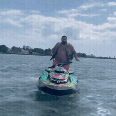 A Man Is Riding A Jet Ski On The Water GIF