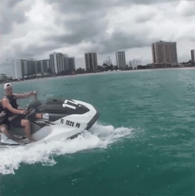 A Man Is Riding A Jet Ski With A License Plate That Says Fl 7028 Pm GIF