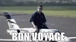 A Man Is Riding A Model Airplane On A Runway And The Words Bon Voyage Are Above Him . GIF